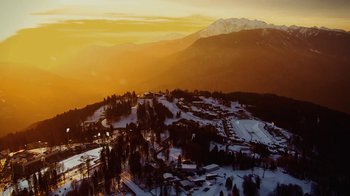 Movie still from “Icarus” (2017), directed by Bryan Fogel – An aerial view of a ski resort at sunset; Extreme Wide shot, High angle