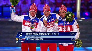 Movie still from “Icarus” (2017), directed by Bryan Fogel – Three men standing next to each other holding medals; Wide shot, Overhead angle