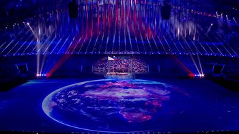 Movie still from “Icarus” (2017), directed by Bryan Fogel – A stage that has lights and a map of the world on it; Extreme Wide shot, High angle