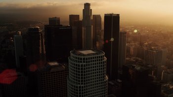 Movie still from “Icarus” (2017), directed by Bryan Fogel – A view of a city skyline at sunset from a helicopter; Extreme Wide shot, High angle