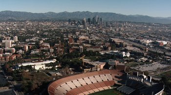 Movie still from “Icarus” (2017), directed by Bryan Fogel – An aerial view of a stadium and a large city; Extreme Wide shot, High angle