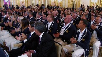 Movie still from “Icarus” (2017), directed by Bryan Fogel – A group of people sitting in a room; Wide shot, High angle