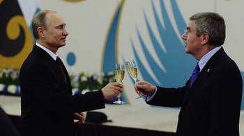 Movie still from “Icarus” (2017), directed by Bryan Fogel – Two men in suits are toasting each other with champagne; Medium shot, Over the shoulder angle