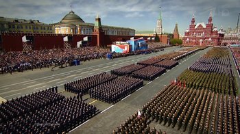 Movie still from “Icarus” (2017), directed by Bryan Fogel – A large group of people are standing in a parade; Extreme Wide shot, High angle