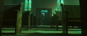 Movie still from “In the Tall Grass” (2019), directed by Vincenzo Natali – A person standing in front of a door in a church; Extreme Wide shot, Low angle