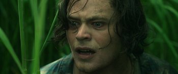 Movie still from “In the Tall Grass” (2019), directed by Vincenzo Natali – A person with wet hair; Close Up shot, Low angle