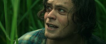 Movie still from “In the Tall Grass” (2019), directed by Vincenzo Natali – A man with long hair; Close Up shot, Low angle