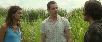Movie still from “In the Tall Grass” (2019), directed by Vincenzo Natali – A man standing next to a field of tall grass; Close Up shot, Over the shoulder angle