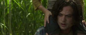 Movie still from “In the Tall Grass” (2019), directed by Vincenzo Natali – A man with a hand on a woman's shoulder; Close Up shot, Low angle