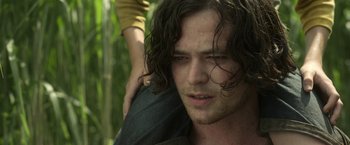 Movie still from “In the Tall Grass” (2019), directed by Vincenzo Natali – A person with long hair; Close Up shot, Over the shoulder angle