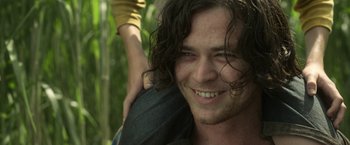 Movie still from “In the Tall Grass” (2019), directed by Vincenzo Natali – A person with long curly hair; Close Up shot, Over the shoulder angle