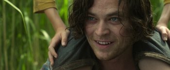 Movie still from “In the Tall Grass” (2019), directed by Vincenzo Natali – A person with long curly hair; Close Up shot, Over the shoulder angle