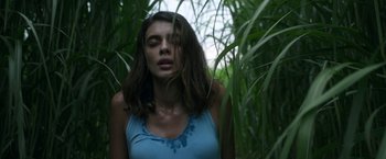 Movie still from “In the Tall Grass” (2019), directed by Vincenzo Natali – A woman standing in the middle of a forest; Close Up shot, Low angle