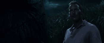 Movie still from “In the Tall Grass” (2019), directed by Vincenzo Natali – A man standing in front of a tree at night; Close Up shot, Over the shoulder angle