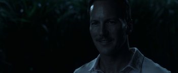 Movie still from “In the Tall Grass” (2019), directed by Vincenzo Natali – A person wearing a white shirt; Close Up shot, Over the shoulder angle