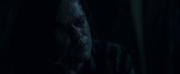 Movie still from “In the Tall Grass” (2019), directed by Vincenzo Natali – A person in a dark room; Close Up shot, Over the shoulder angle