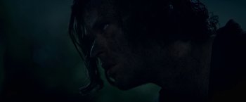 Movie still from “In the Tall Grass” (2019), directed by Vincenzo Natali – A man's face in the dark; Close Up shot, Over the shoulder angle