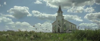 Movie still from “In the Tall Grass” (2019), directed by Vincenzo Natali – An old church in the middle of a grassy field; Extreme Wide shot, Low angle