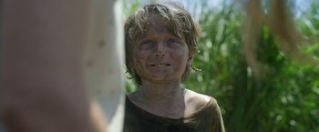 Movie still from “In the Tall Grass” (2019), directed by Vincenzo Natali – A young boy is looking into the distance; Close Up shot, Low angle