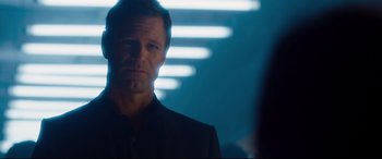 Movie still from “Incarnate” (2016), directed by Brad Peyton – A person wearing a suit and tie; Close Up shot, Over the shoulder angle