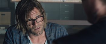Movie still from “Incarnate” (2016), directed by Brad Peyton – A person wearing glasses and a plaid shirt; Close Up shot, Over the shoulder angle