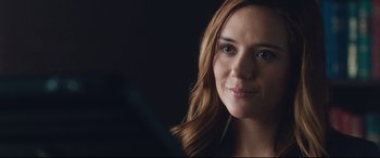 Movie still from “Incarnate” (2016), directed by Brad Peyton – A woman's face in a dark room; Close Up shot, Over the shoulder angle