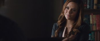 Movie still from “Incarnate” (2016), directed by Brad Peyton – A beautiful young woman sitting in front of a laptop computer; Close Up shot, Over the shoulder angle