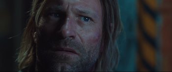 Movie still from “Incarnate” (2016), directed by Brad Peyton – A man with long hair and blue eyes; Close Up shot, Low angle