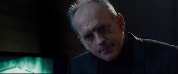 Movie still from “Incarnate” (2016), directed by Brad Peyton – An older man is looking at the camera; Close Up shot, Low angle