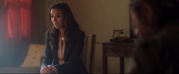 Movie still from “Incarnate” (2016), directed by Brad Peyton – A woman sitting in a chair in a room; Medium shot, Over the shoulder angle