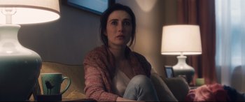 Movie still from “Incarnate” (2016), directed by Brad Peyton – A woman sitting on a couch in a living room; Close Up shot, Over the shoulder angle