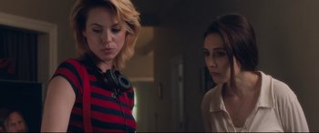 Movie still from “Incarnate” (2016), directed by Brad Peyton – Two women standing next to each other in front of a wall; Close Up shot, Over the shoulder angle