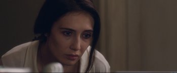Movie still from “Incarnate” (2016), directed by Brad Peyton – A person sitting in a room; Close Up shot, Over the shoulder angle