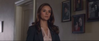 Movie still from “Incarnate” (2016), directed by Brad Peyton – A woman with long hair wearing a jacket; Close Up shot, Over the shoulder angle