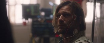 Movie still from “Incarnate” (2016), directed by Brad Peyton – A person wearing headphones; Close Up shot, Over the shoulder angle