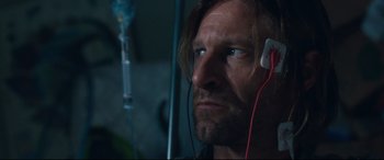 Movie still from “Incarnate” (2016), directed by Brad Peyton – A person wearing ear phones; Close Up shot, Over the shoulder angle