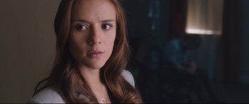 Movie still from “Incarnate” (2016), directed by Brad Peyton – A person with long brown hair; Close Up shot, Over the shoulder angle
