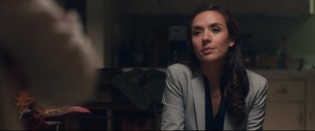 Movie still from “Incarnate” (2016), directed by Brad Peyton – A woman sitting in a chair in front of a window; Close Up shot, Over the shoulder angle