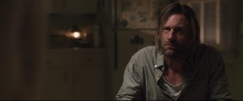 Movie still from “Incarnate” (2016), directed by Brad Peyton – A person sitting in a room; Close Up shot, Over the shoulder angle