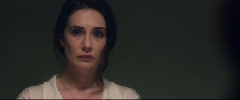 Movie still from “Incarnate” (2016), directed by Brad Peyton – A person wearing a white shirt; Close Up shot, Over the shoulder angle