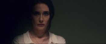 Movie still from “Incarnate” (2016), directed by Brad Peyton – A young woman with blue eyes is looking at the camera; Close Up shot, High angle