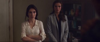 Movie still from “Incarnate” (2016), directed by Brad Peyton – Two women standing next to each other in front of a wall; Medium shot, Over the shoulder angle