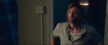 Movie still from “Incarnate” (2016), directed by Brad Peyton – A person wearing a shirt and tie; Medium shot, Over the shoulder angle