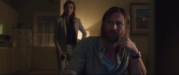 Movie still from “Incarnate” (2016), directed by Brad Peyton – A man and a woman are standing in a dark room; Medium shot, Over the shoulder angle
