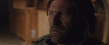 Movie still from “Incarnate” (2016), directed by Brad Peyton – A person with long hair and a beard; Close Up shot, Over the shoulder angle