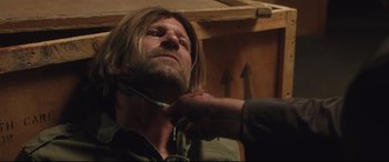 Movie still from “Incarnate” (2016), directed by Brad Peyton – A man with long hair is being shaved by another man; Close Up shot, Over the shoulder angle