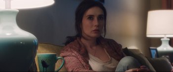 Movie still from “Incarnate” (2016), directed by Brad Peyton – A woman sitting on a couch with a cup of coffee; Close Up shot, Over the shoulder angle