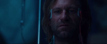 Movie still from “Incarnate” (2016), directed by Brad Peyton – A person wearing headphones and looking sad; Close Up shot, Low angle