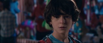 Movie still from “Incarnate” (2016), directed by Brad Peyton – A young boy is looking into the distance; Close Up shot, Over the shoulder angle