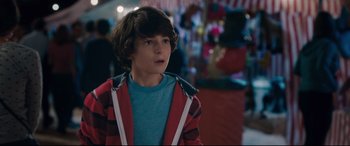 Movie still from “Incarnate” (2016), directed by Brad Peyton – A boy in a blue shirt and a red and black jacket; Close Up shot, Over the shoulder angle